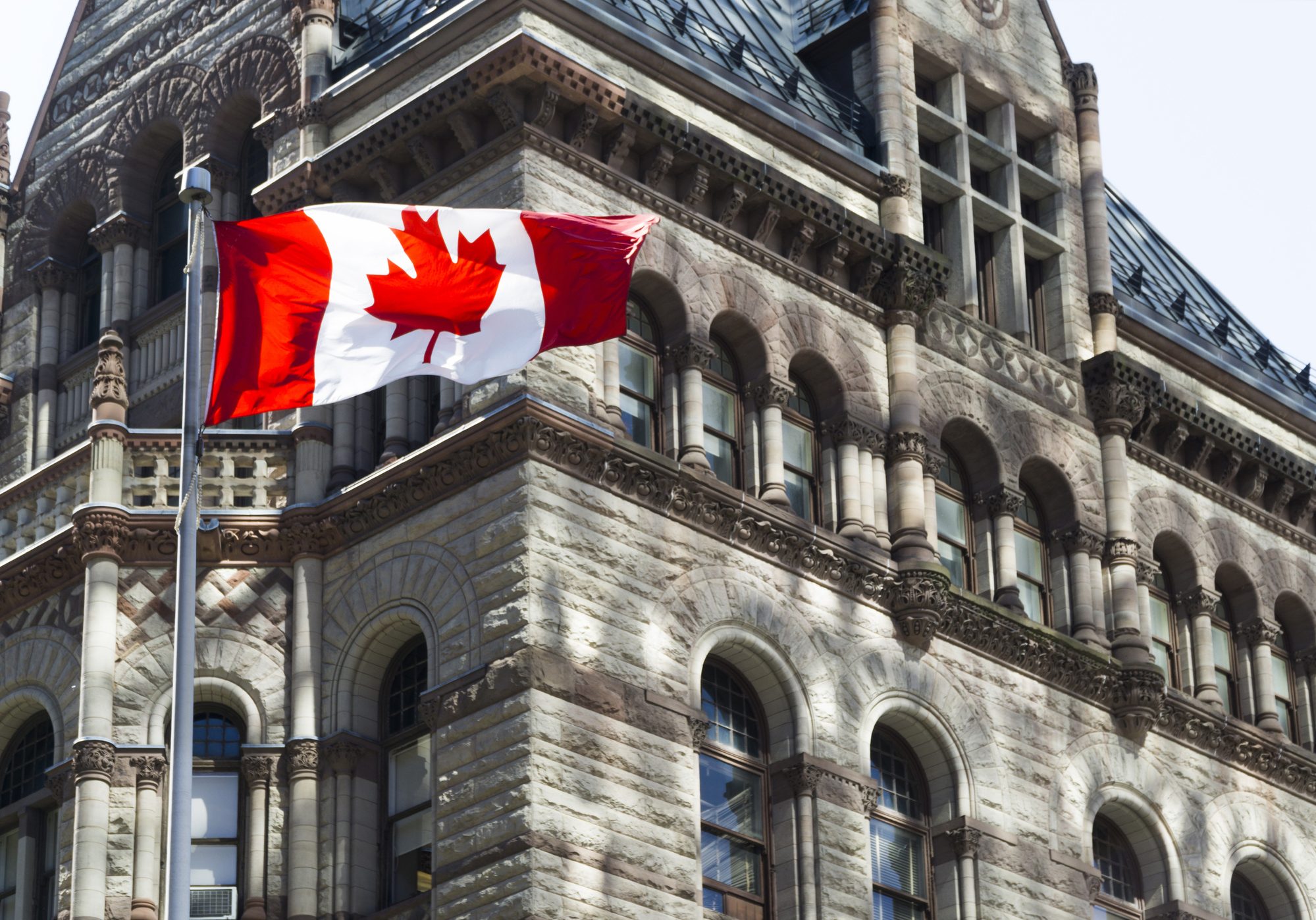 Beautiful Canada flag is waving front of a historical building